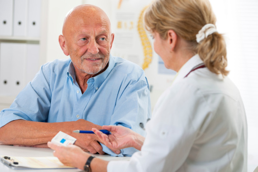 A male patient discusses cirrhosis treatment with a female physician.