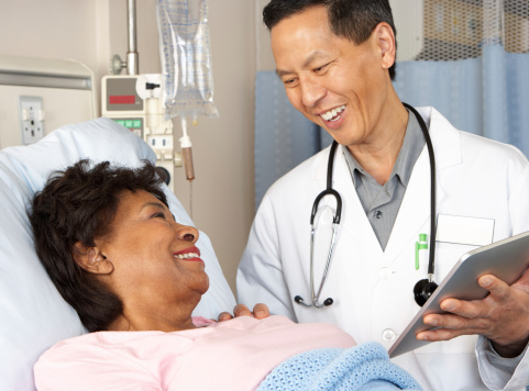 A doctor discusses surgical resection with a female patient.
