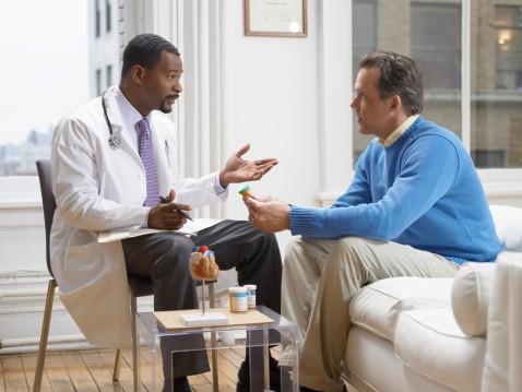 A doctor discusses local ablation and embolization treatment options with patient who cannot have liver surgery.