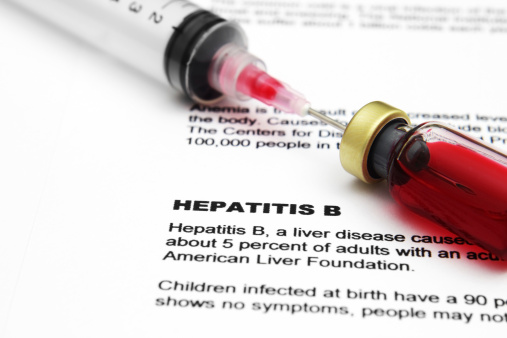 A syringe and vial that are used for viral hepatitis blood tests.