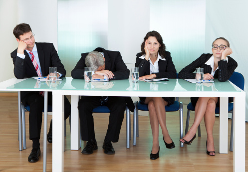 A group of business people sitting in an office could be subjected to sedentary lifestyle risks.