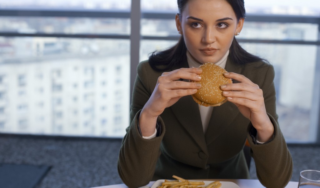 A woman with ulcerative colitis cautiously eats.