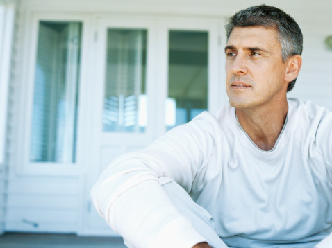 A baby boomer man sits on stairs and considers hepatitis C.